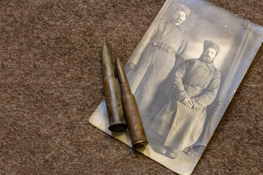 Photo of two soldiers in period of World War I and rifle bullets on trench coat WW1