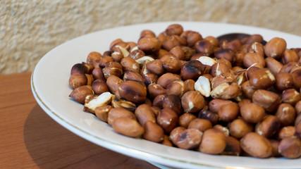 Roasted Peanuts Snack in White Plate in Wooden Backgrounds - topview ans Closeup