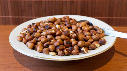 Roasted Peanuts Snack in White Plate in Wooden Backgrounds - topview ans Closeup