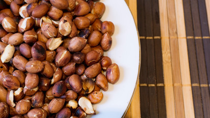 Roasted Peanuts Snack in White Plate in Wooden Backgrounds - topview ans Closeup