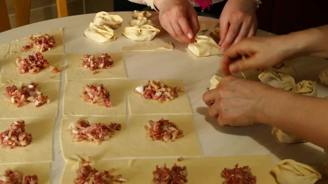 Kyrgyz ravioli, a woman doing ravioli, meat ravioli, pasty woman who.make ravioli with dough.