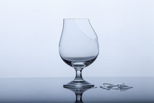 empty broken wine glass with fragments on white background