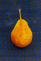 one pear tasty yellow juicy on blue background appetizing snack lunch lunch fruit dappled...