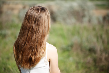 Fototapeta premium girl standing with her back in the field