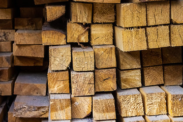 stack square blocks timber building materials lumber end of the board close-up background light beige
