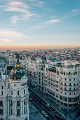 Fotobehang View of Gran Via from the Circulo de Bellas Artes rooftop at sunset, in Madrid, Spain © jonbilous