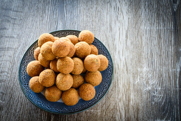 Deep fried fish balls on a bowl on wooden background