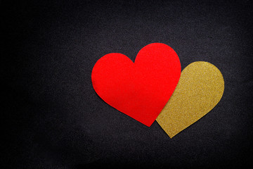 Love hearts on black background. Valentine's day card concept. Gold and red heart on black background