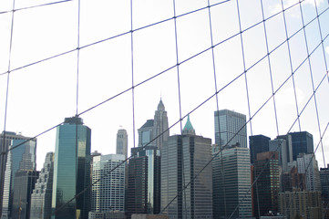 Obraz na płótnie Canvas A cluster of buildings on New York City's lower Manhattan as seen from the Brooklyn Bridge.