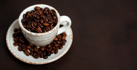 Coffee cup and beans on a concrete table