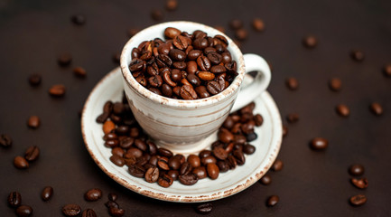 Coffee cup and beans on a concrete table