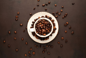 Coffee cup and beans on a concrete table