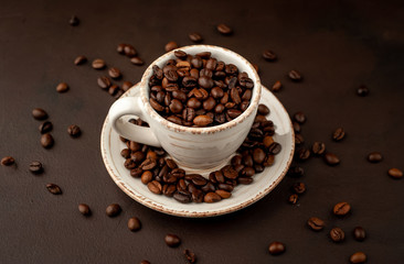 Coffee cup and beans on a concrete table