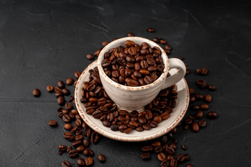 Coffee cup and beans on a concrete table