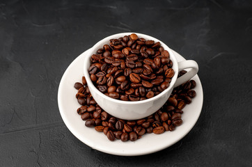 Coffee cup and beans on a concrete table