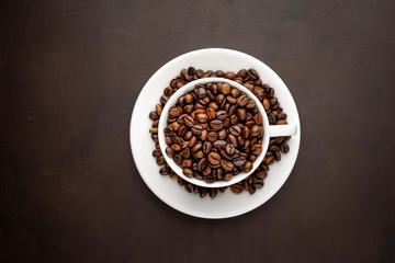 Coffee cup and beans on a concrete table