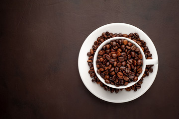 Coffee cup and beans on a concrete table