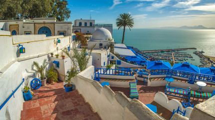Fototapeta na wymiar Sidi Bou Said beautiful panoramic view on seaside and cafe terrace. Tunisia.