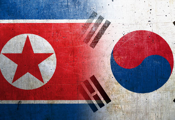 North Korea and South Korea flags on the grunge metal background