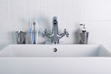 New plumbing. Chrome faucet and white sink in the bathroom.
