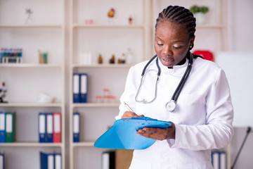 Black female doctor working at clinic 