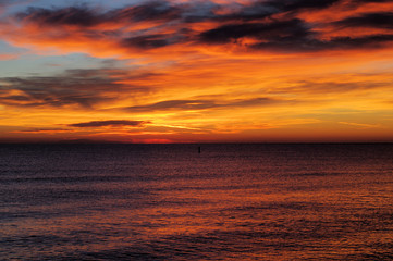 sunrise over the sea,horizon,seascape,water,light,water,clouds,red,orange