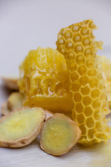 honeycombs, transparent glass mug with herbal tea and a slice of lemon close-up on the table. postcard, space for text.