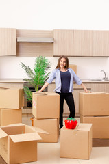 Young beautiful woman moving to new flat