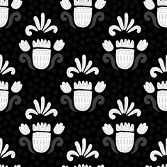 white floral ornament on a dark color with gray dots