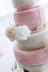 Wedding cake with floral decoration and delicate icing pattern