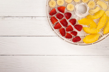 Tray of Fruit Being Prepared to Dehydrate on a Wooden Table