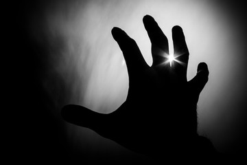 hand reaching for help to the light
