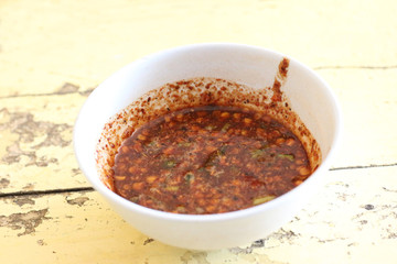 chili sauce over wooden background