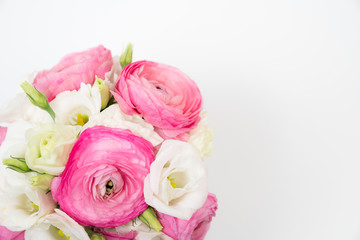 Ranunculus and lisiathus floral bouquet flat lay on white background