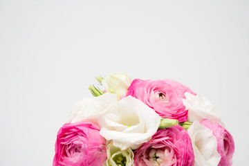 Ranunculus and lisiathus floral bouquet flat lay on white background
