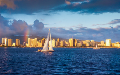 Yacht sailing at sunset in Waikiki