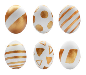 Set of painted golden Easter eggs on white background