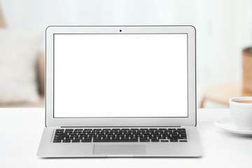 Fototapeta premium Laptop with blank screen on table indoors. Space for text