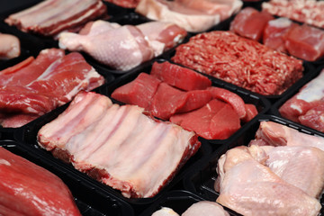 Containers with different raw meat, closeup view