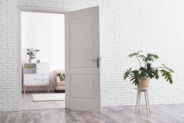 Room interior with new furniture, view through open door