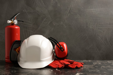 Composition with safety equipment on table against grey background. Space for text