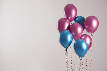 Bright balloons on light background. Space for text