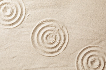 Obraz premium Zen garden pattern on sand as background, top view. Meditation and harmony