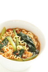 Korean spicy instant ramen with green leaf vegetable