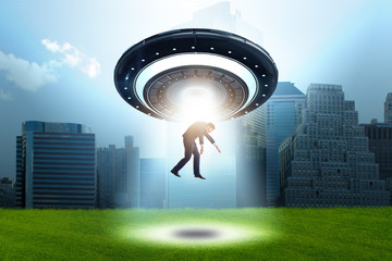 Flying saucer abducting young businessman 