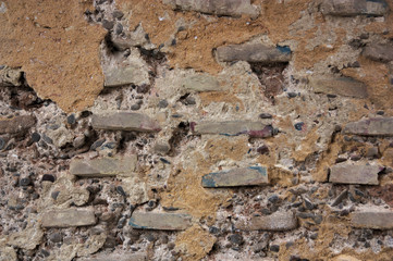 Texture of old wall with bricks in sight