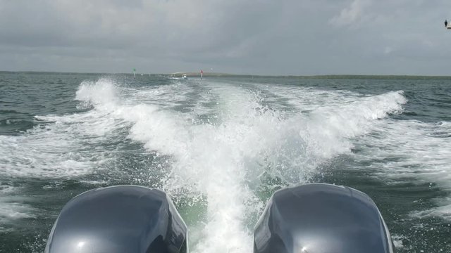 High definition slow motion video of the rear view of a outboard motor boat cruising along Biscayne Bay in Miami.
