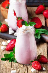 Strawberry smoothies and cocktails with fresh berry and green mint, decorated marshmellow, selective focus