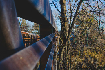 The frosty steel rails along the park bridge in the early morning light. 