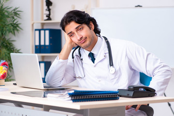 Young doctor cardiologist working in the clinic 